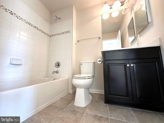 full bathroom with toilet, tiled shower / bath, and vanity