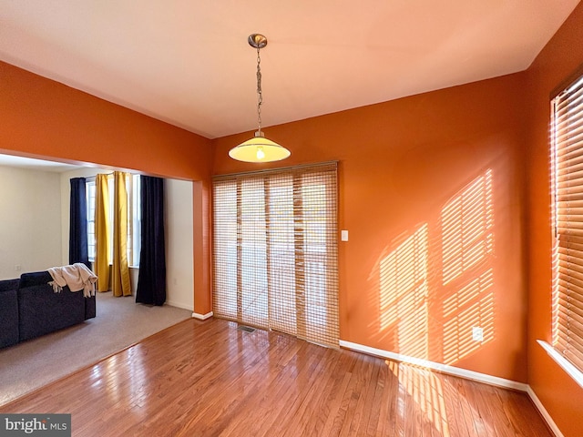 unfurnished dining area with hardwood / wood-style floors