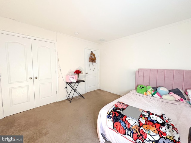 bedroom with carpet, a closet, and ornamental molding