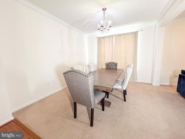 carpeted dining room featuring ornamental molding and a chandelier