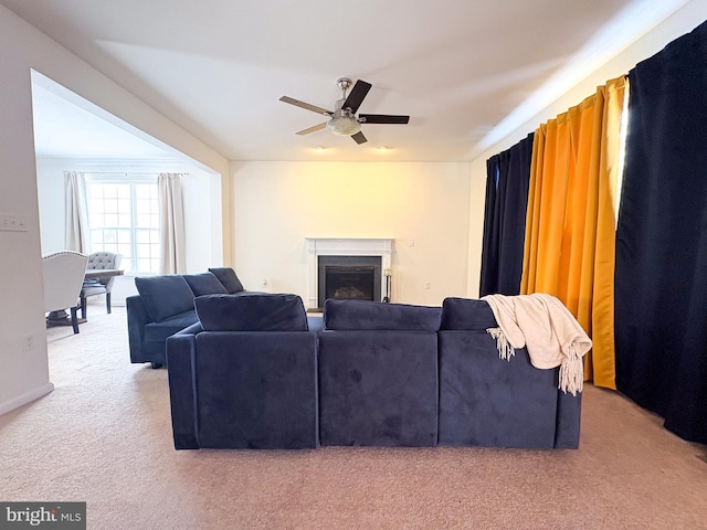 carpeted living room featuring ceiling fan