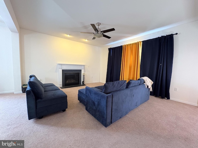 carpeted living room featuring ceiling fan