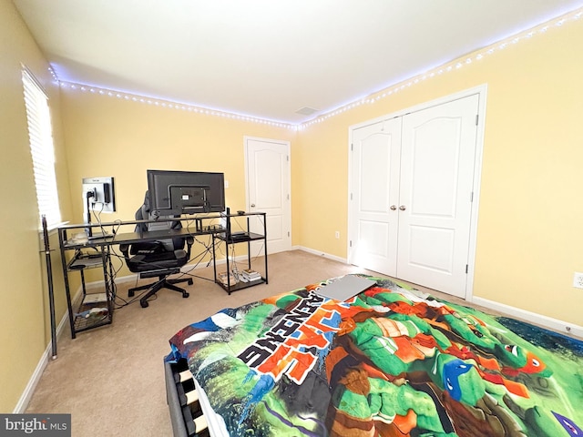 carpeted bedroom with a closet