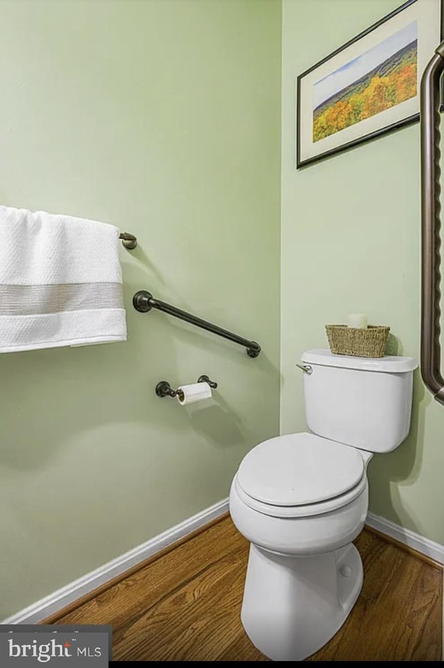 bathroom featuring wood-type flooring and toilet