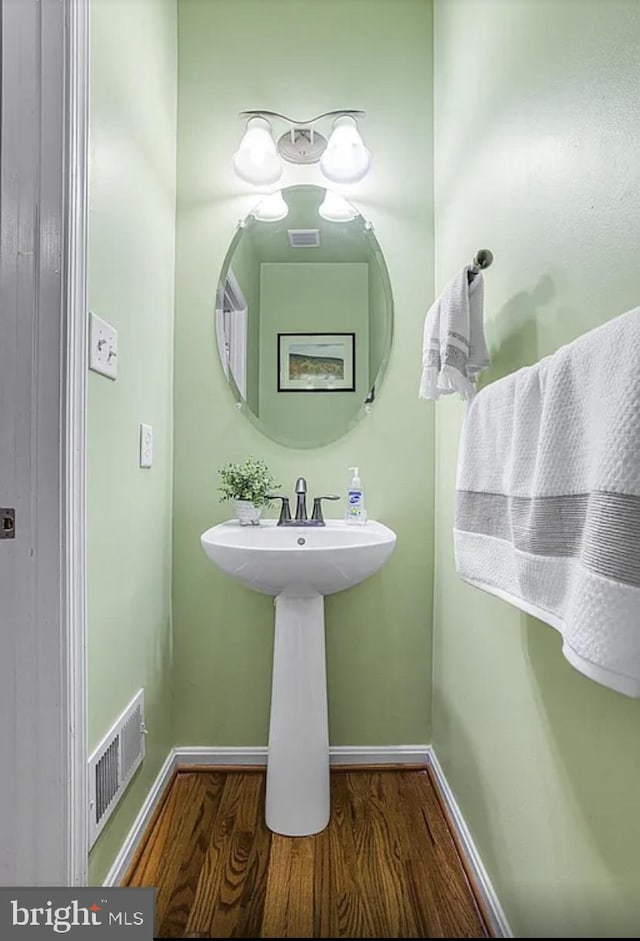 bathroom with hardwood / wood-style floors and sink