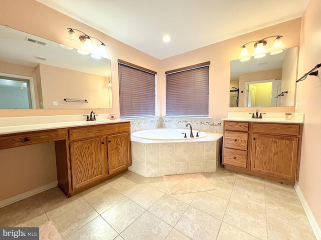 bathroom with tile patterned flooring, vanity, and a relaxing tiled tub