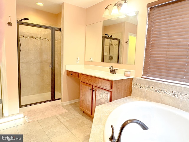 bathroom with tile patterned floors, vanity, and shower with separate bathtub