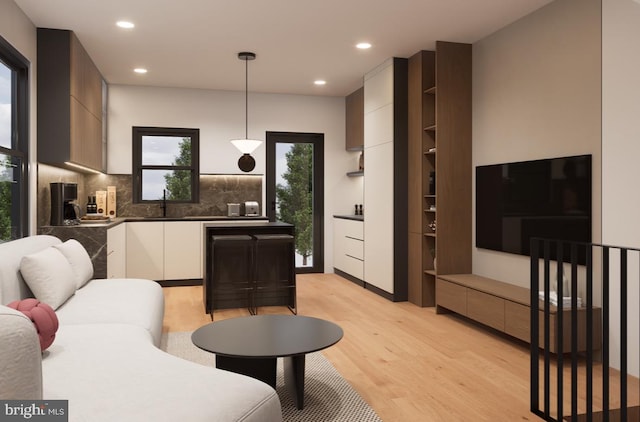 living room with sink and light wood-type flooring