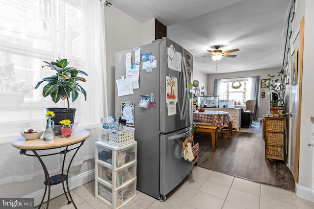 kitchen with light hardwood / wood-style floors, stainless steel fridge, and ceiling fan