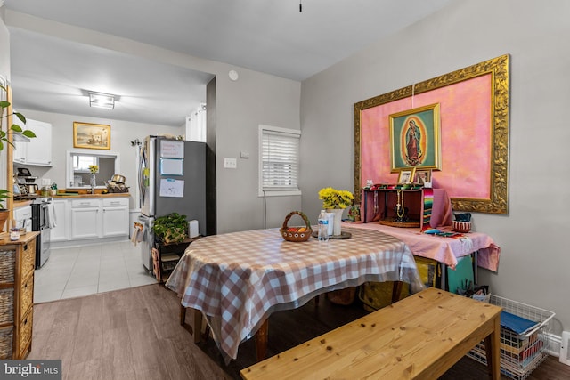 dining space with light hardwood / wood-style flooring