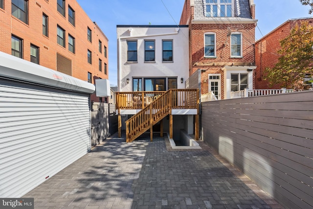 rear view of property featuring a deck