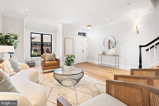 living room with light hardwood / wood-style floors and ornamental molding