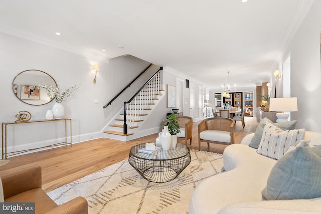 living room featuring hardwood / wood-style flooring, an inviting chandelier, and ornamental molding