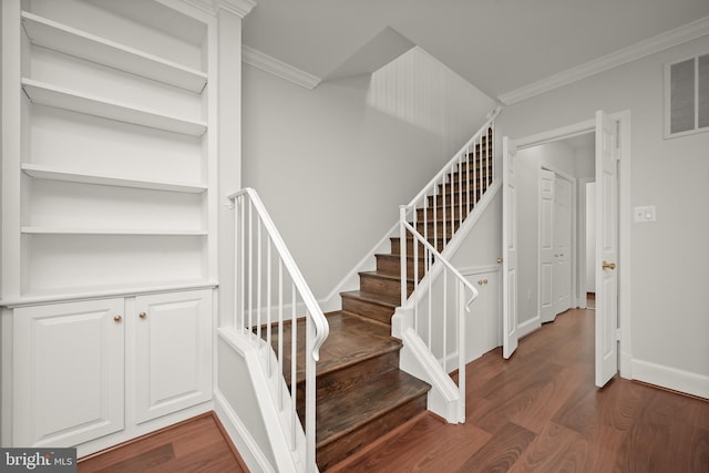 staircase featuring crown molding and hardwood / wood-style floors