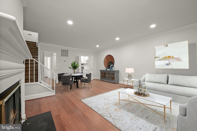 living room featuring crown molding and hardwood / wood-style flooring