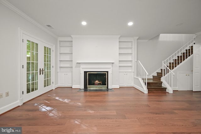 unfurnished living room with french doors, hardwood / wood-style flooring, and ornamental molding