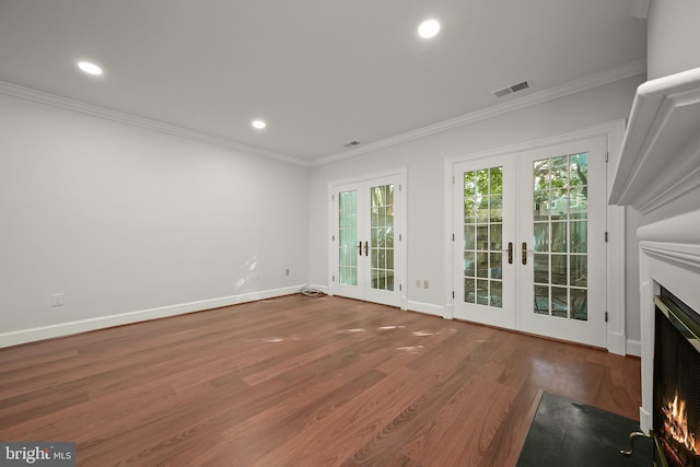 unfurnished living room with french doors, ornamental molding, and dark hardwood / wood-style flooring