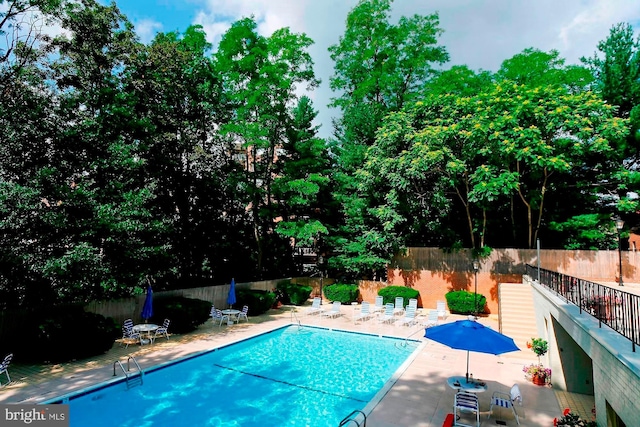 view of swimming pool featuring a patio area