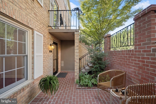 view of patio featuring a balcony