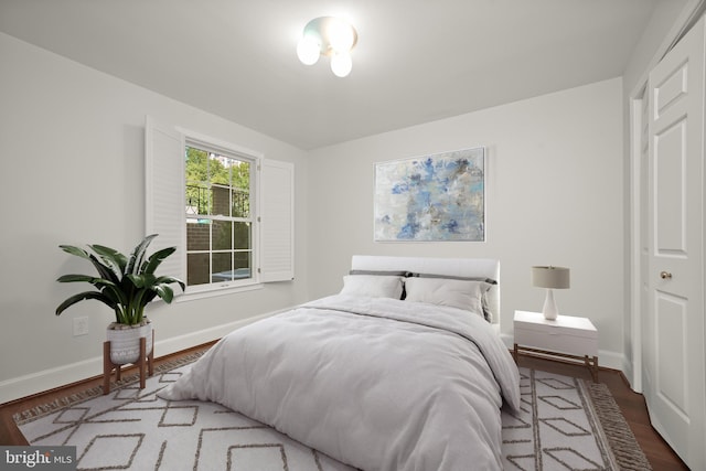 bedroom with a closet and hardwood / wood-style floors