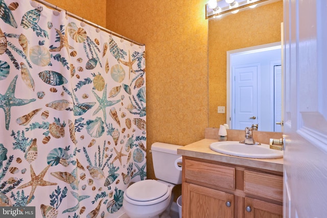 bathroom featuring toilet, a shower with curtain, and vanity