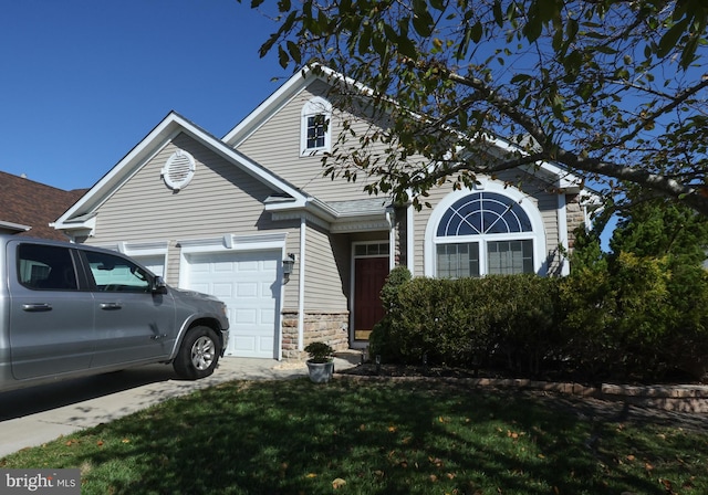 view of front of home with a garage and a front lawn