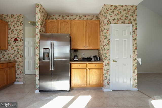 kitchen featuring stainless steel refrigerator with ice dispenser and light tile patterned floors