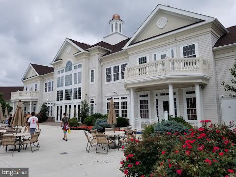 back of house with a balcony and a patio area