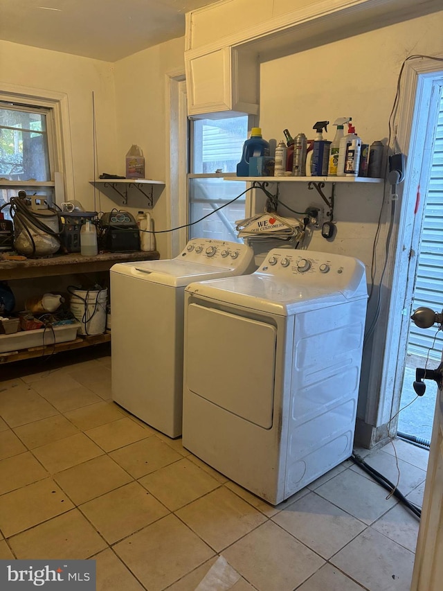 laundry room with light tile patterned flooring and washer and clothes dryer