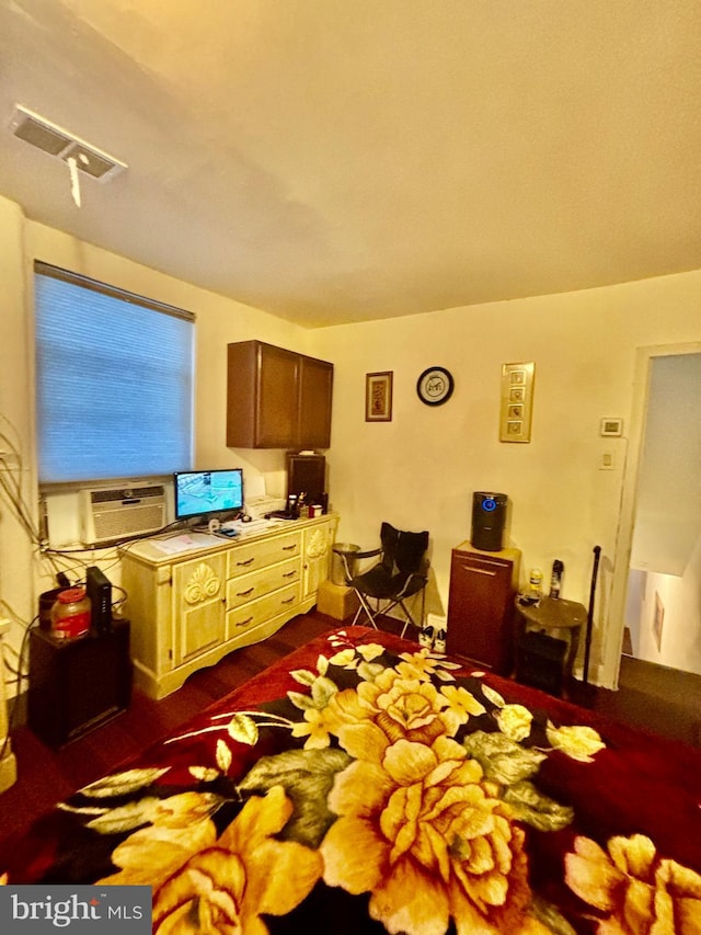 bedroom featuring cooling unit and dark hardwood / wood-style flooring