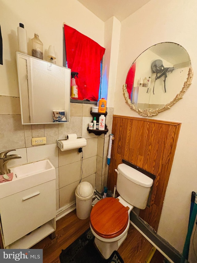 bathroom with vanity, tile walls, wood-type flooring, and toilet