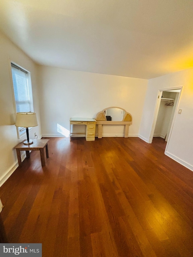 interior space with baseboards and dark wood finished floors