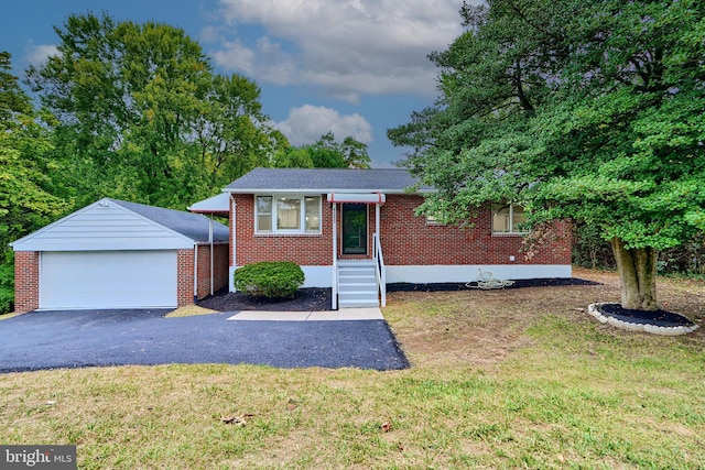 view of front of property with a front yard, an outbuilding, and a garage