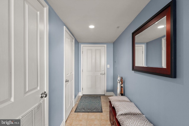 doorway to outside with light tile patterned floors, recessed lighting, and baseboards