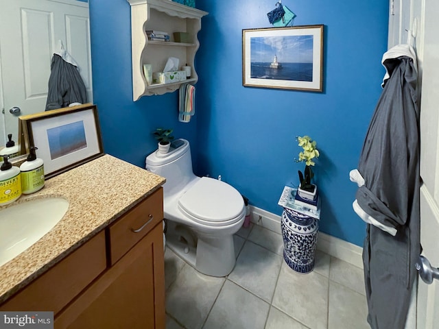 bathroom with vanity, tile patterned floors, and toilet