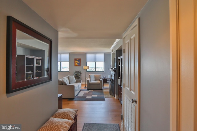 hall with hardwood / wood-style floors