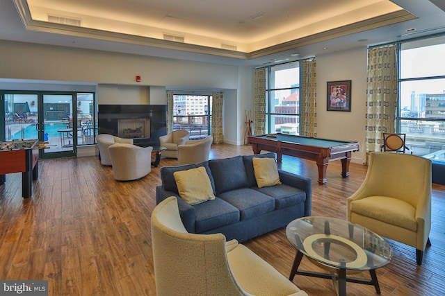 game room with a raised ceiling, billiards, wood finished floors, and baseboards