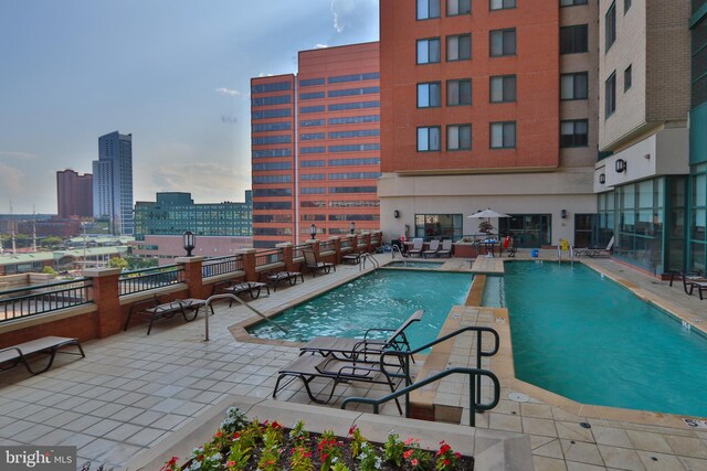 community pool with a patio area