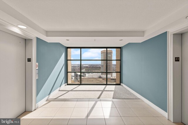 empty room with baseboards and a textured ceiling