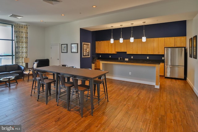 dining area featuring light wood-type flooring and sink