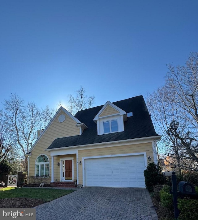 new england style home with a garage