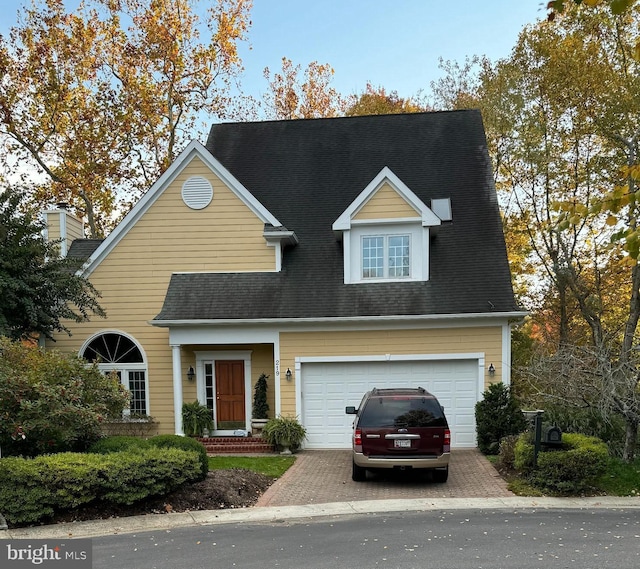 cape cod house with a garage