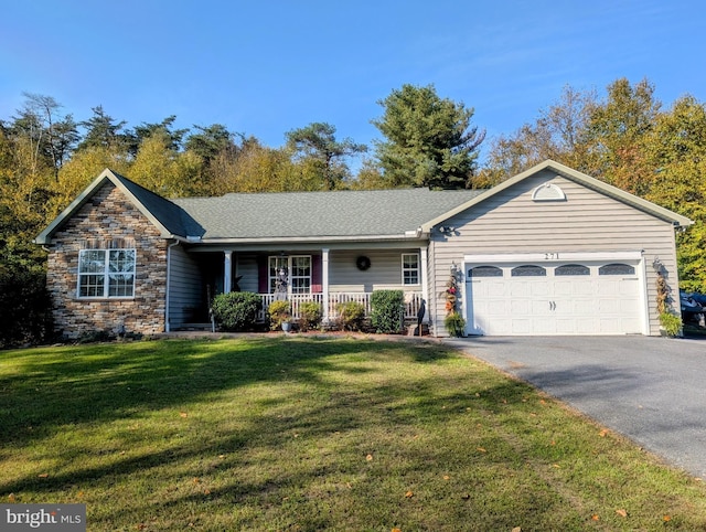 ranch-style house with covered porch, a garage, and a front lawn