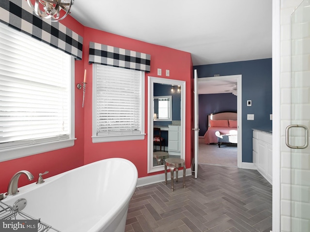 bathroom with parquet flooring, a healthy amount of sunlight, and separate shower and tub