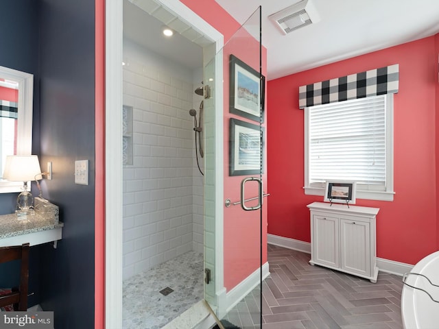 bathroom with parquet floors and an enclosed shower