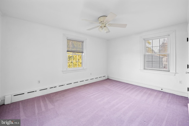 empty room featuring ceiling fan, carpet flooring, a baseboard heating unit, and a wealth of natural light