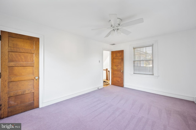 empty room featuring light carpet and ceiling fan