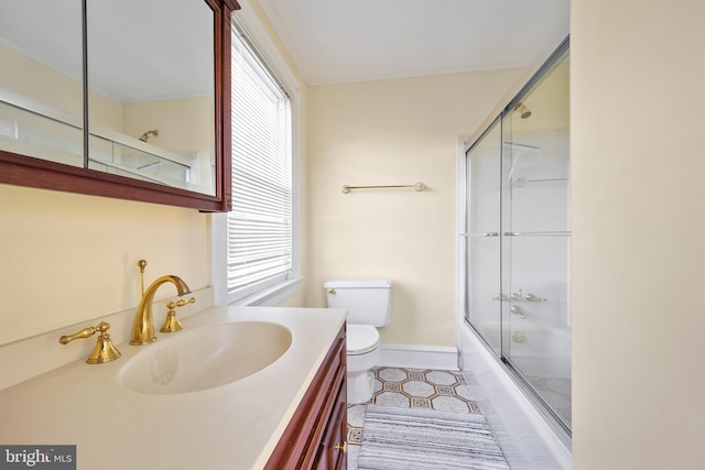 full bathroom featuring vanity, enclosed tub / shower combo, toilet, and tile patterned flooring