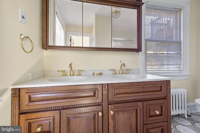 bathroom with vanity, radiator heating unit, and toilet