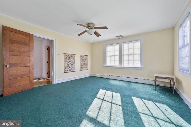 empty room featuring ceiling fan, plenty of natural light, and dark colored carpet